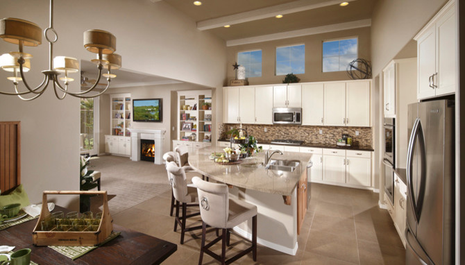 Large contemporary l-shaped eat-in kitchen in Los Angeles with a double-bowl sink, shaker cabinets, white cabinets, quartzite benchtops, beige splashback, mosaic tile splashback, stainless steel appliances, porcelain floors and with island.