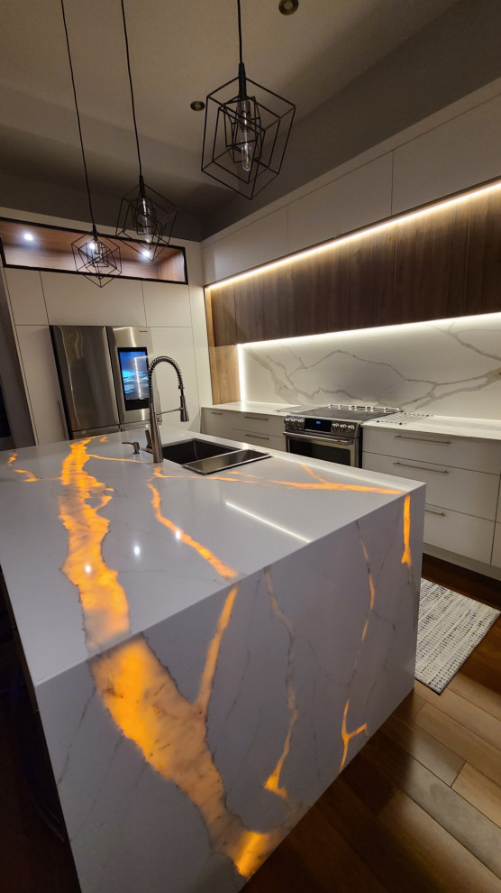 Inspiration for a large contemporary u-shaped eat-in kitchen in Montreal with an undermount sink, glass-front cabinets, white cabinets, quartz benchtops, white splashback, engineered quartz splashback, stainless steel appliances, dark hardwood floors, with island, brown floor and white benchtop.