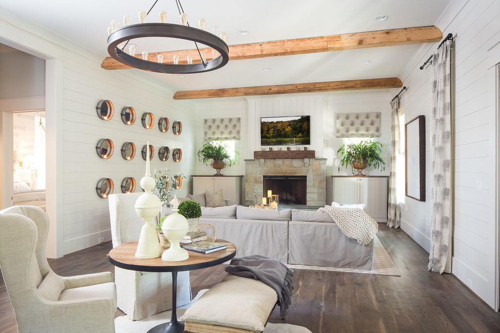 Inspiration for an expansive country open concept living room in Atlanta with white walls, medium hardwood floors, a standard fireplace, a stone fireplace surround and a wall-mounted tv.