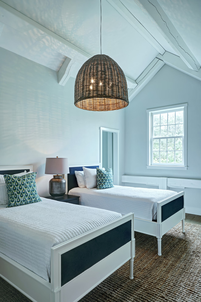 Mid-sized beach style guest medium tone wood floor and beige floor bedroom photo with gray walls