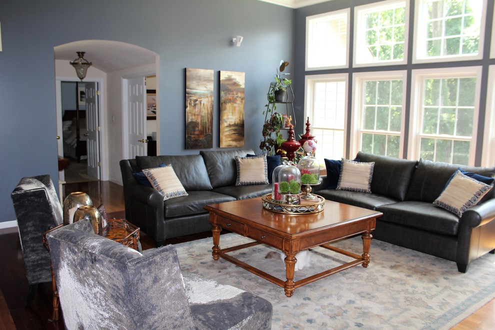 Photo of a mid-sized transitional open concept living room in St Louis with blue walls and medium hardwood floors.