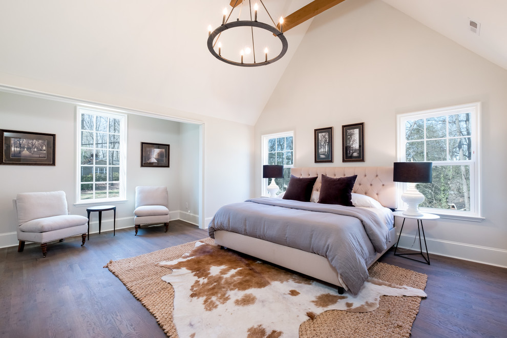Country bedroom in Charlotte with white walls, dark hardwood floors and brown floor.