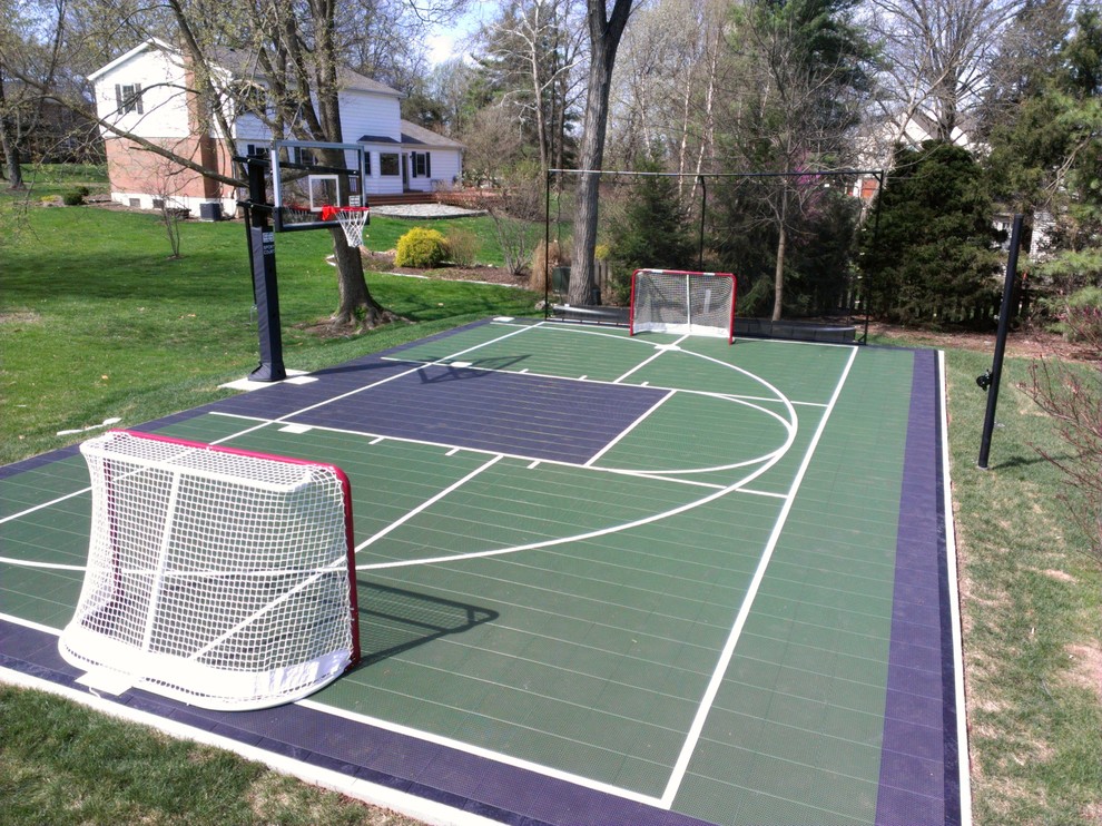 This is an example of a large traditional full sun backyard outdoor basketball/tennis/multi-game court in St Louis for fall.