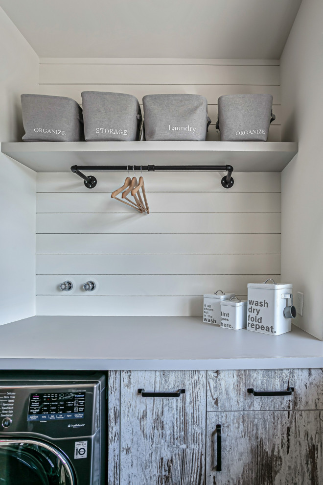 Design ideas for a small industrial u-shaped dedicated laundry room in Calgary with flat-panel cabinets, distressed cabinets, laminate benchtops, white splashback, shiplap splashback, ceramic floors, grey floor and grey benchtop.