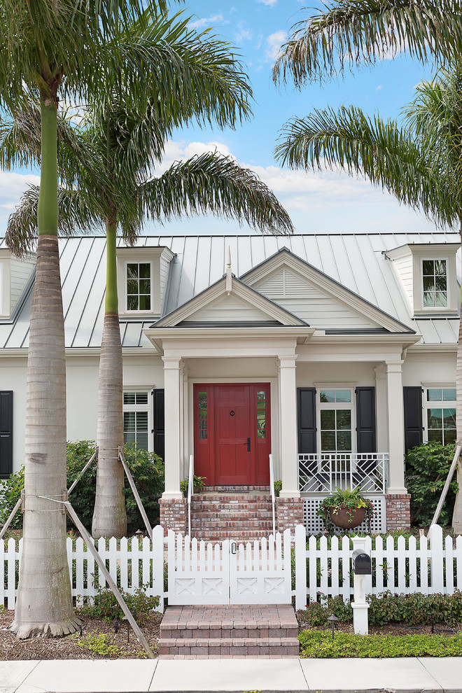 This is an example of a mid-sized traditional front door in Tampa with white walls, a single front door and a red front door.