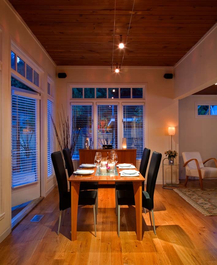 Large contemporary open plan dining in Vancouver with beige walls, dark hardwood floors, no fireplace and brown floor.