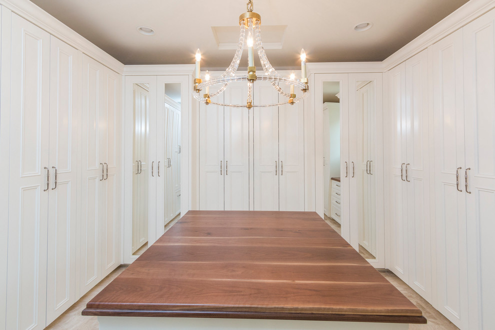 Photo of an expansive transitional gender-neutral walk-in wardrobe in Phoenix with raised-panel cabinets, white cabinets, marble floors and beige floor.