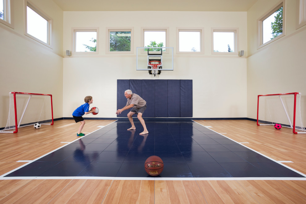 This is an example of a transitional indoor sport court in Minneapolis with white walls and light hardwood floors.