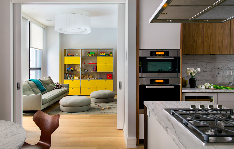 Contemporary kitchen in New York with quartzite benchtops, stainless steel appliances, flat-panel cabinets, medium wood cabinets, white splashback and stone slab splashback.