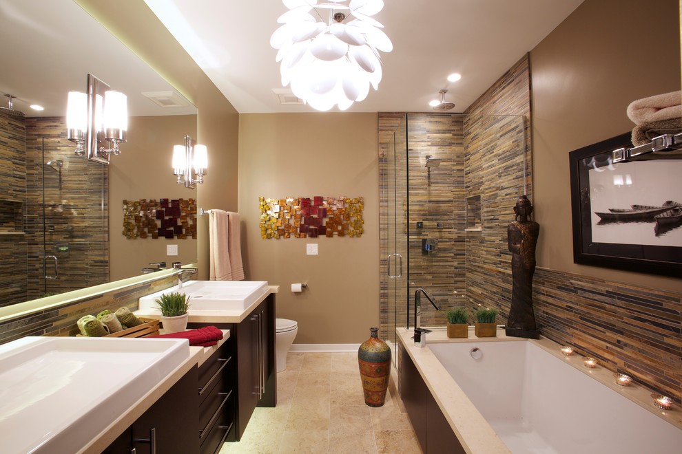 Design ideas for a large asian master bathroom in Chicago with flat-panel cabinets, dark wood cabinets, multi-coloured tile, an undermount tub, a corner shower, a one-piece toilet, matchstick tile, beige walls, travertine floors, a vessel sink and solid surface benchtops.