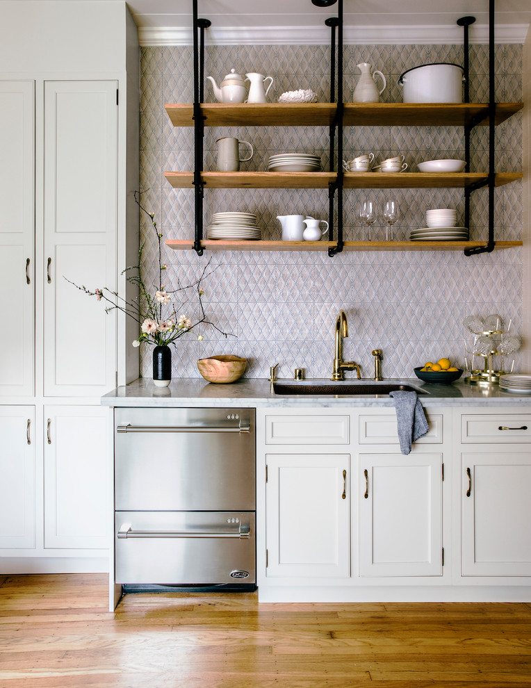 Inspiration for a large traditional kitchen in San Francisco with an undermount sink, white cabinets, marble benchtops, pink splashback, ceramic splashback, stainless steel appliances, light hardwood floors, beaded inset cabinets and brown floor.