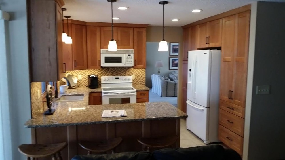 Open concept kitchen - mid-sized transitional u-shaped ceramic tile and beige floor open concept kitchen idea with a double-bowl sink, shaker cabinets, light wood cabinets, granite countertops, beige backsplash, mosaic tile backsplash, white appliances and a peninsula