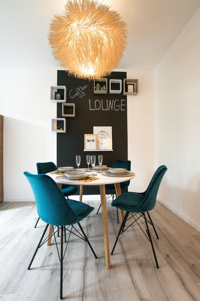 Design ideas for a small contemporary separate dining room in Cologne with laminate floors and brown floor.