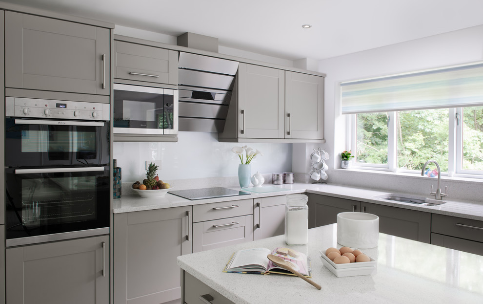 This is an example of a contemporary kitchen in Cornwall with with island.