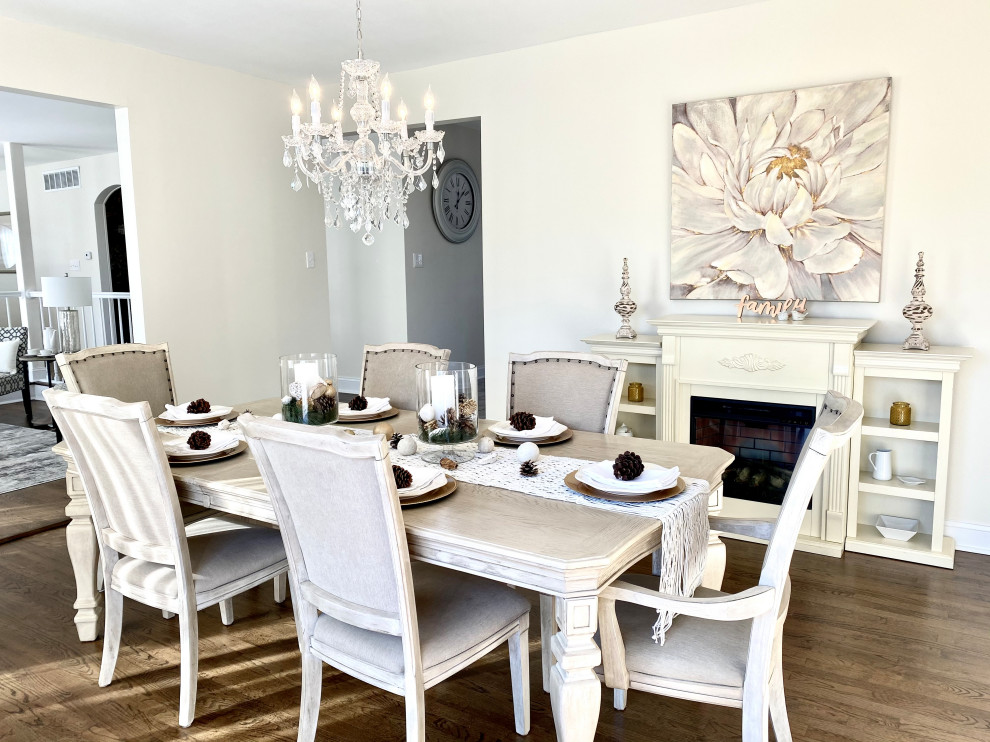 Inspiration for a large transitional dining room in Other with white walls, medium hardwood floors, a ribbon fireplace and brown floor.