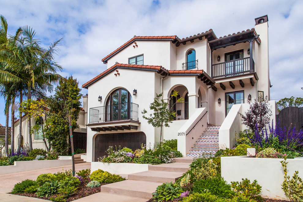Mediterranean two-storey stucco white exterior in Los Angeles with a gable roof.