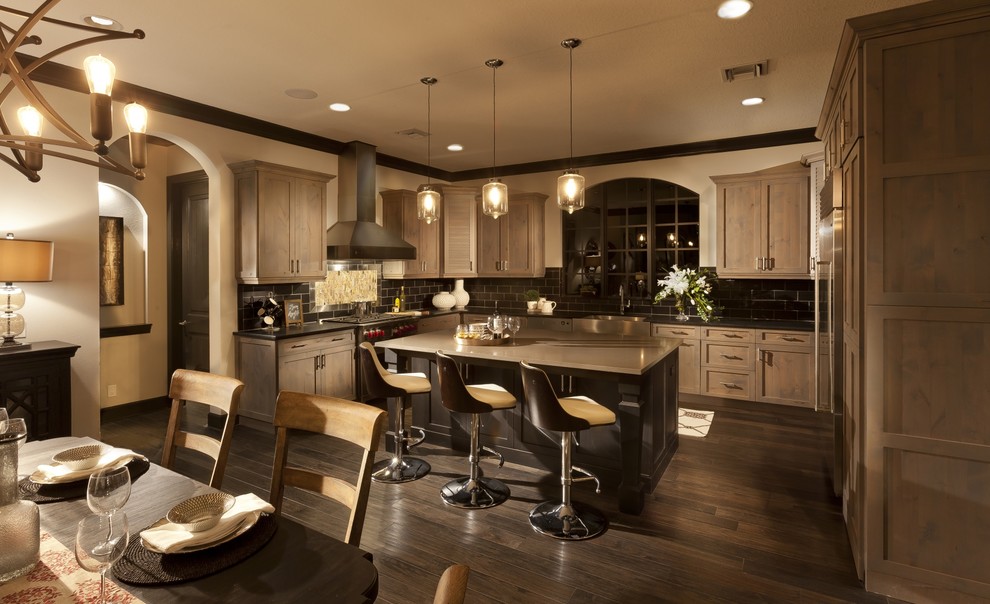 Inspiration for a transitional u-shaped dark wood floor eat-in kitchen remodel in Tampa with a farmhouse sink, shaker cabinets, medium tone wood cabinets, quartzite countertops, black backsplash, porcelain backsplash, stainless steel appliances and an island