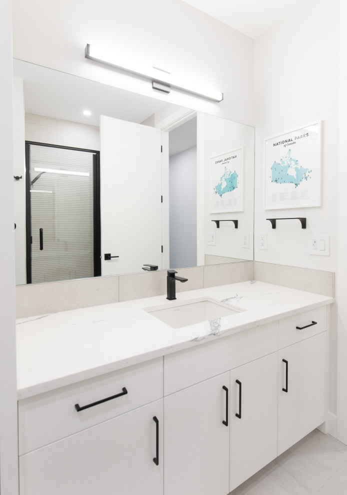 Alcove bathtub - large transitional kids' white tile and porcelain tile porcelain tile, white floor and single-sink alcove bathtub idea in Calgary with flat-panel cabinets, white cabinets, a two-piece toilet, white walls, an undermount sink, quartzite countertops, white countertops, a niche and a built-in vanity