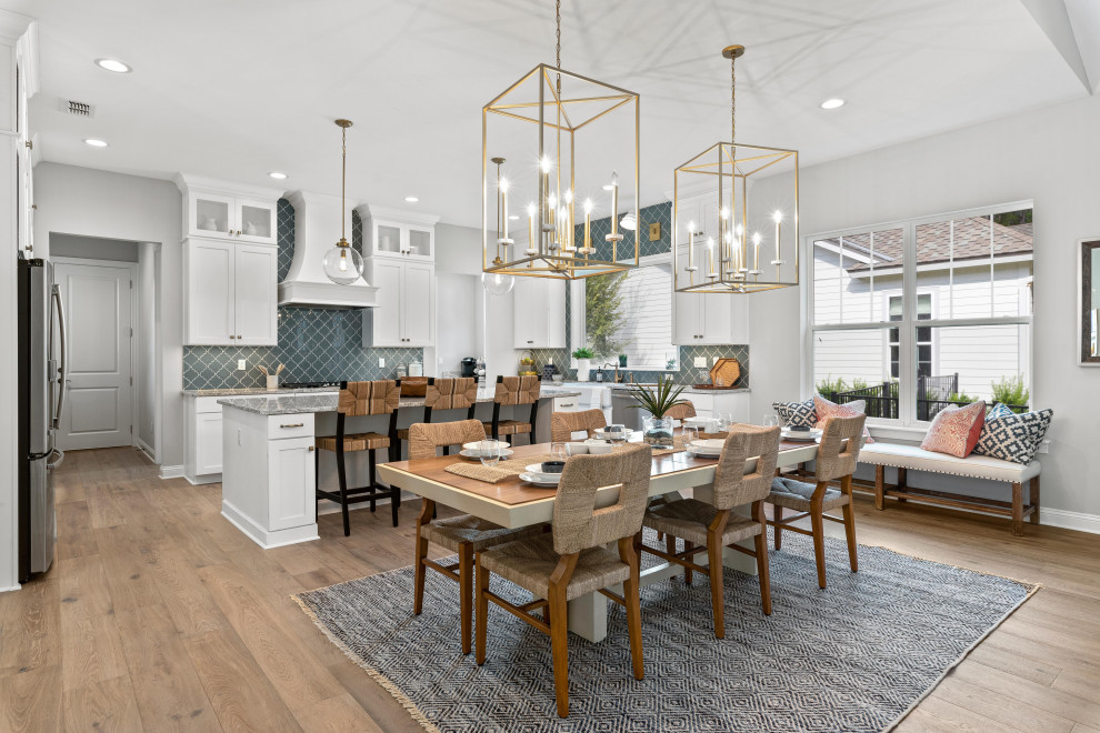 This is an example of a large country kitchen/dining combo in Jacksonville with white walls, light hardwood floors, no fireplace and brown floor.