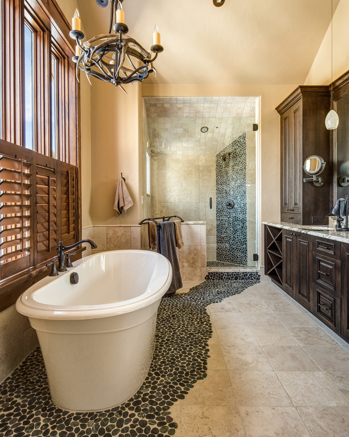 Inspiration for a large country master bathroom in Denver with a drop-in sink, raised-panel cabinets, dark wood cabinets, marble benchtops, a japanese tub, an open shower, a two-piece toilet, multi-coloured tile, stone tile, beige walls and travertine floors.