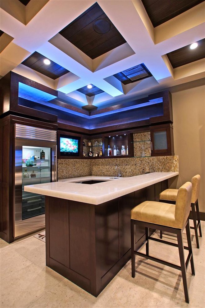This is an example of a large contemporary home bar in Las Vegas with travertine floors.