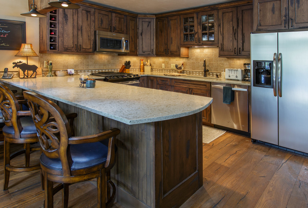 Mountain style kitchen photo in Denver with furniture-like cabinets and distressed cabinets