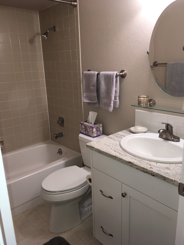 Photo of a small traditional 3/4 bathroom in Boise with shaker cabinets, white cabinets, an alcove tub, a shower/bathtub combo, a two-piece toilet, beige tile, porcelain tile, beige walls, ceramic floors, a drop-in sink, quartzite benchtops, beige floor and a shower curtain.