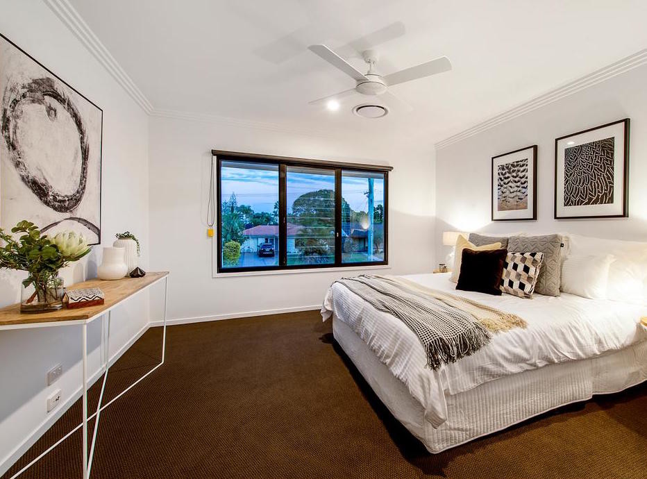 Photo of a mid-sized contemporary master bedroom in Gold Coast - Tweed with white walls, carpet and brown floor.