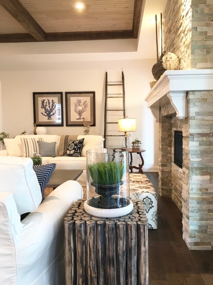 Inspiration for a country living room in New York with grey walls, dark hardwood floors, a two-sided fireplace and a stone fireplace surround.