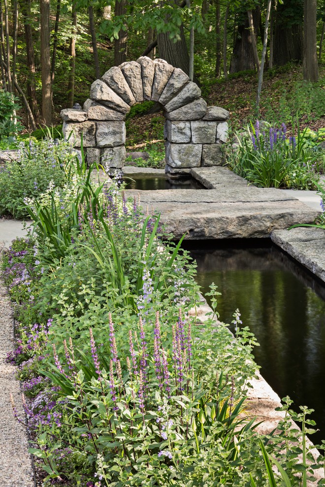 This is an example of a traditional garden in New York with a water feature.