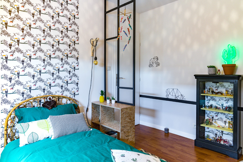 This is an example of a mid-sized contemporary gender-neutral kids' room for kids 4-10 years old in Paris with yellow walls, dark hardwood floors and brown floor.