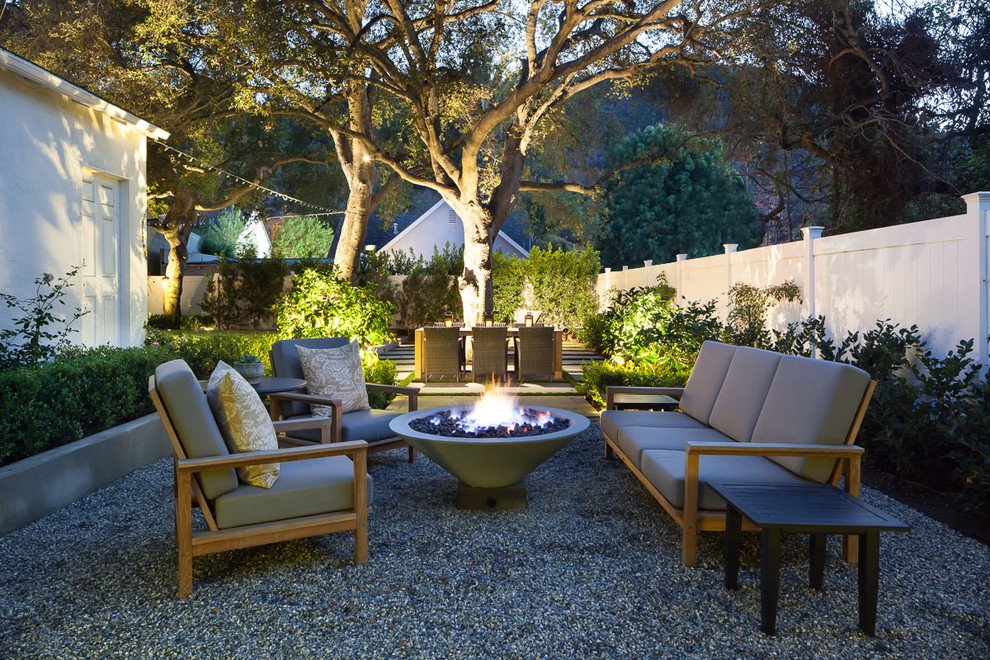 Mid-sized traditional backyard patio in Los Angeles with a fire feature, gravel and no cover.