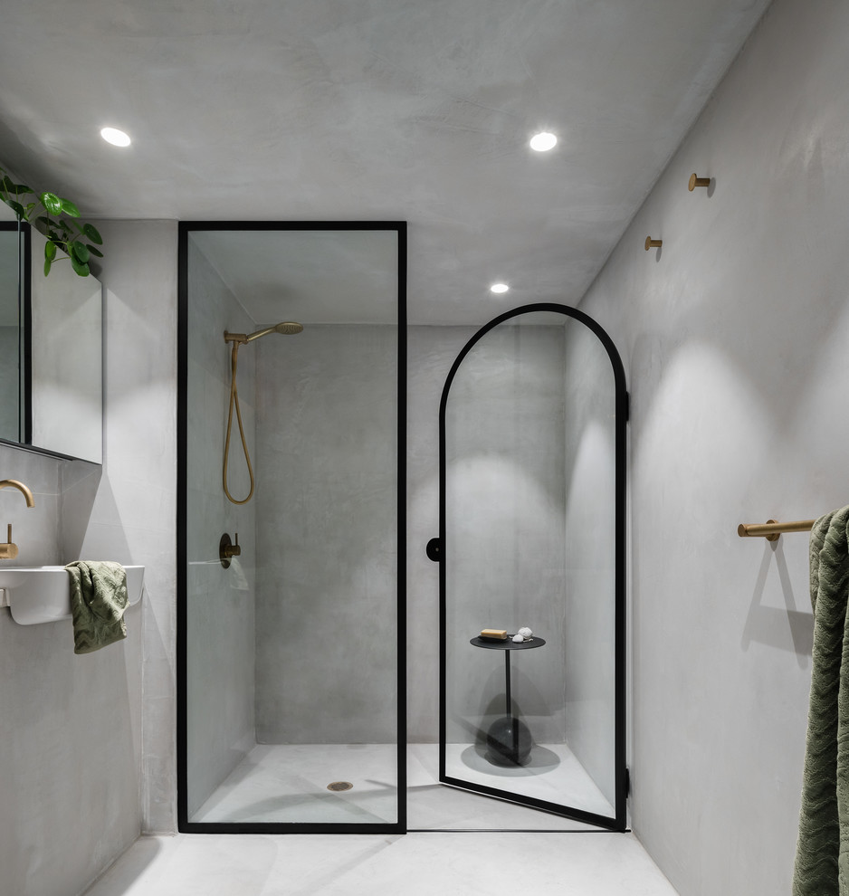 Small modern master bathroom in Sydney with flat-panel cabinets, grey cabinets, an alcove shower, gray tile, grey walls, concrete floors, concrete benchtops, grey floor, a hinged shower door and grey benchtops.