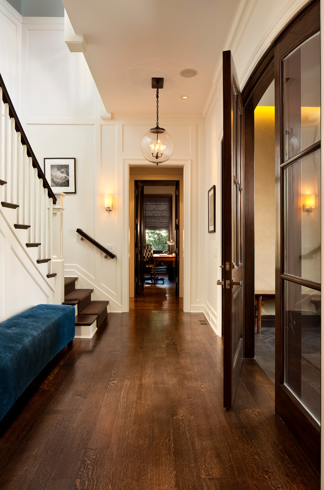 Photo of a mid-sized traditional hallway in Chicago with white walls and dark hardwood floors.