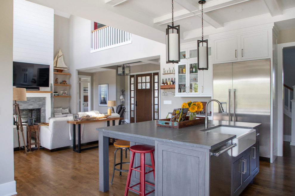 Inspiration for a large transitional l-shaped open plan kitchen in Milwaukee with a farmhouse sink, recessed-panel cabinets, white cabinets, quartz benchtops, grey splashback, engineered quartz splashback, stainless steel appliances, dark hardwood floors, with island, grey benchtop and coffered.