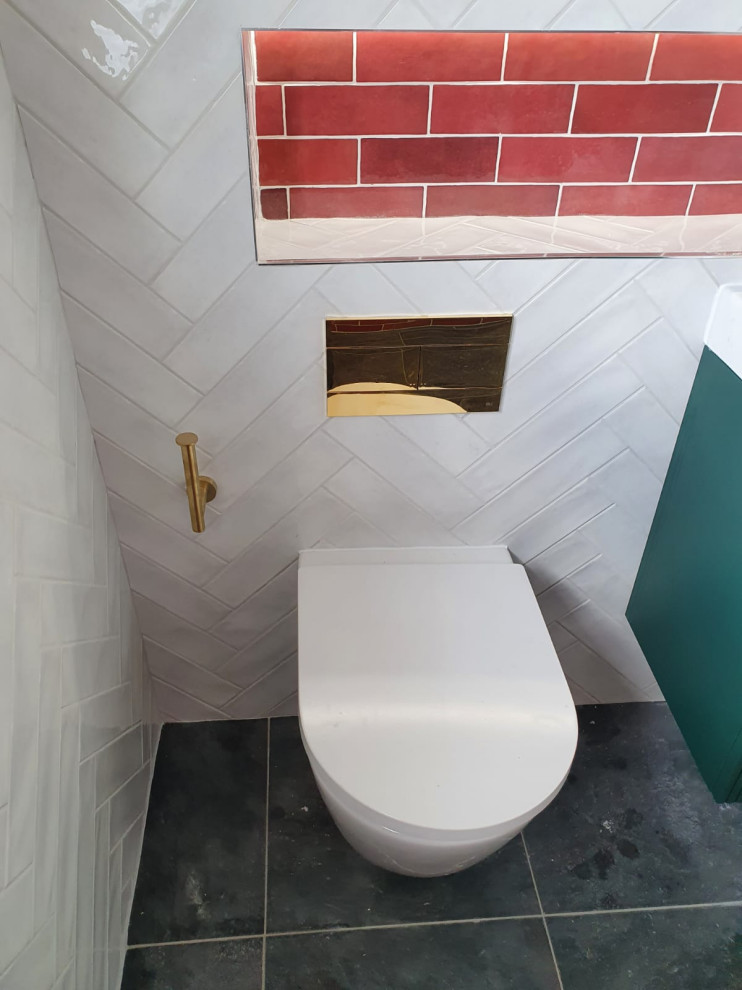Design ideas for a mid-sized contemporary master wet room bathroom in Dublin with furniture-like cabinets, green cabinets, a wall-mount toilet, white tile, porcelain tile, red walls, porcelain floors, a drop-in sink, black floor, an open shower, a shower seat, a single vanity and a floating vanity.