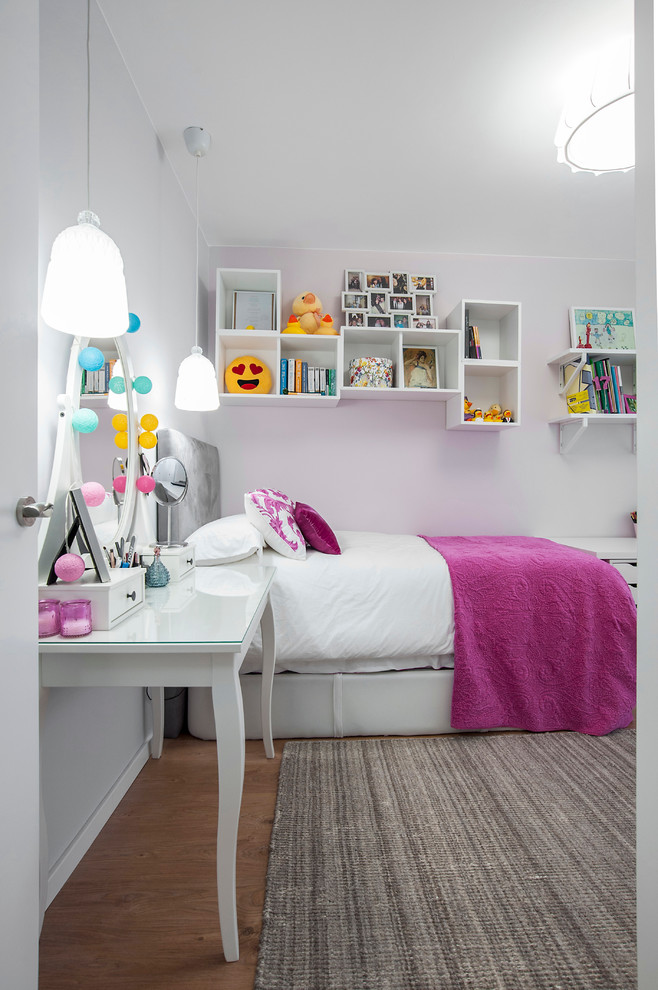 This is an example of a mid-sized scandinavian kids' room for girls in Other with white walls and medium hardwood floors.