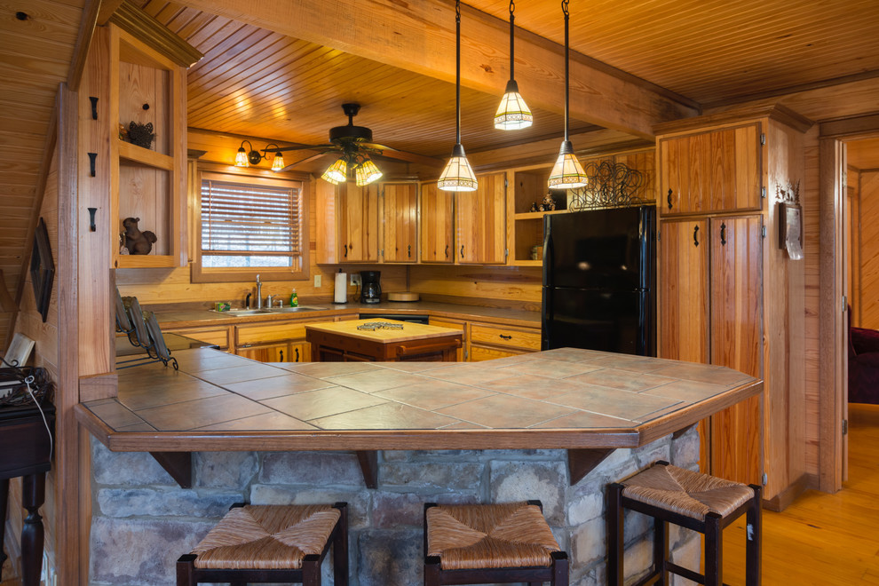 This is an example of a country u-shaped kitchen in Oklahoma City with black appliances.