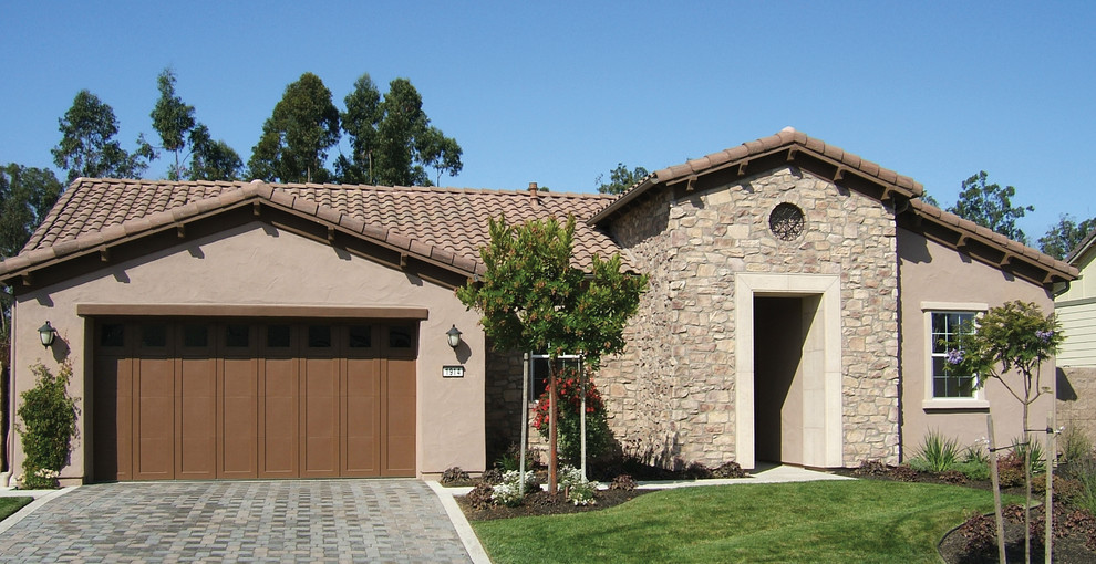 Large rustic beige two-story stone exterior home idea