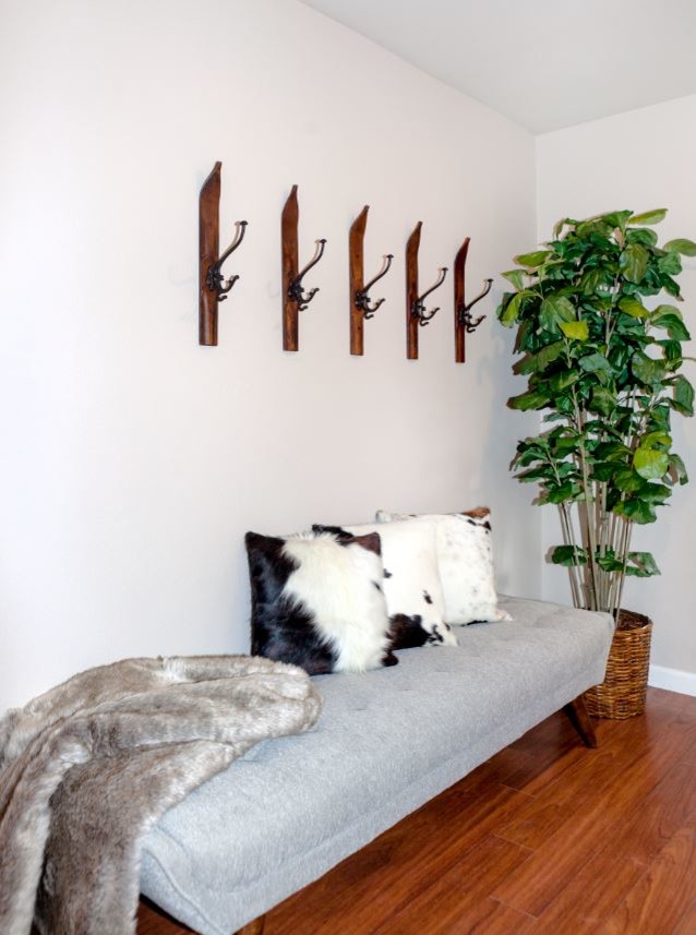 Example of a small mountain style medium tone wood floor and brown floor foyer design with beige walls and a white front door