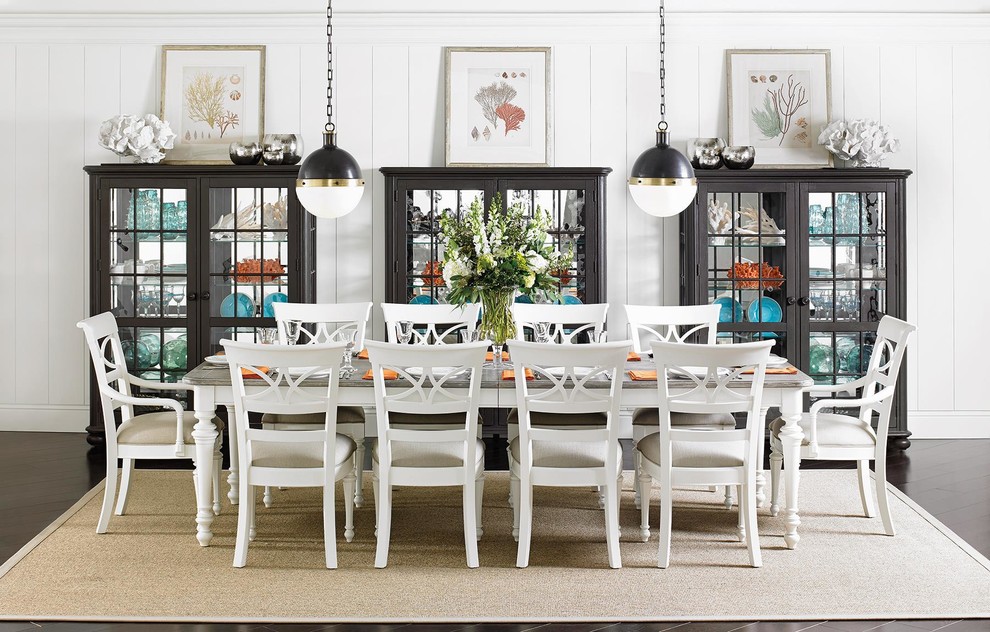 Photo of a mid-sized beach style separate dining room in Orange County with white walls, dark hardwood floors, no fireplace and brown floor.
