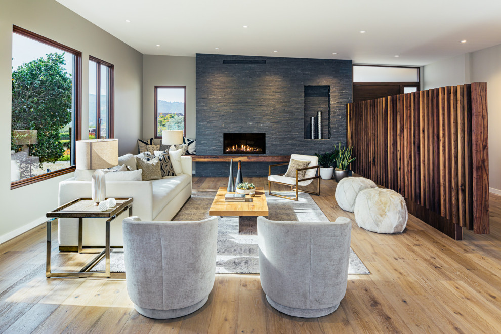 Design ideas for a transitional formal open concept living room in Sacramento with brown walls, medium hardwood floors, a standard fireplace, no tv and brown floor.
