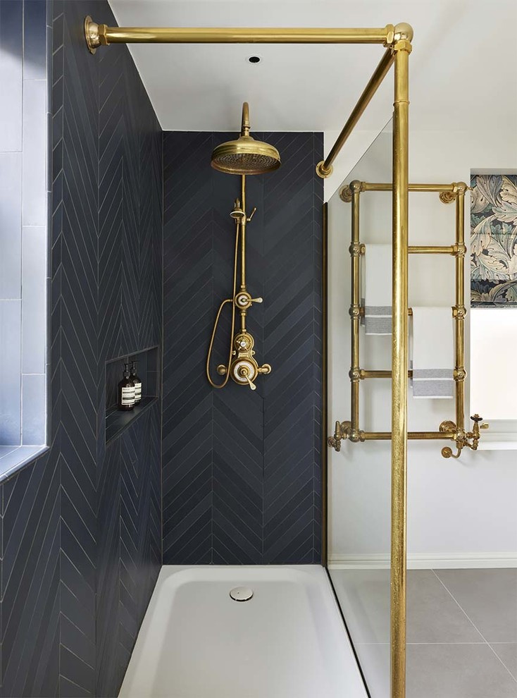 This is an example of a traditional 3/4 bathroom in London with a corner shower and black walls.
