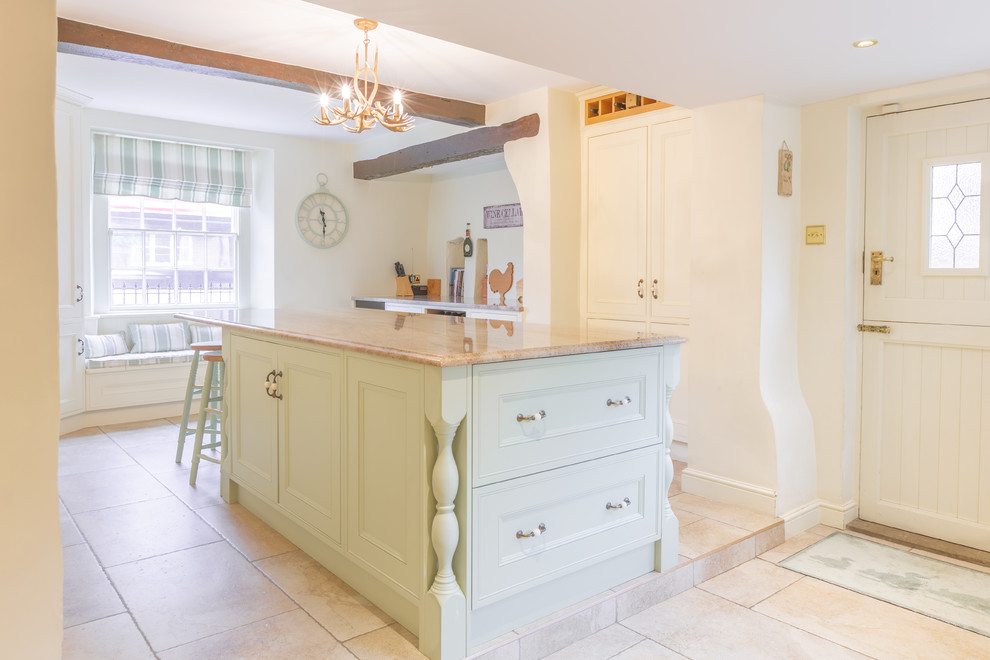Photo of a small traditional eat-in kitchen in Other with a farmhouse sink, beaded inset cabinets, white cabinets, granite benchtops, coloured appliances, porcelain floors, with island, multi-coloured floor and beige benchtop.