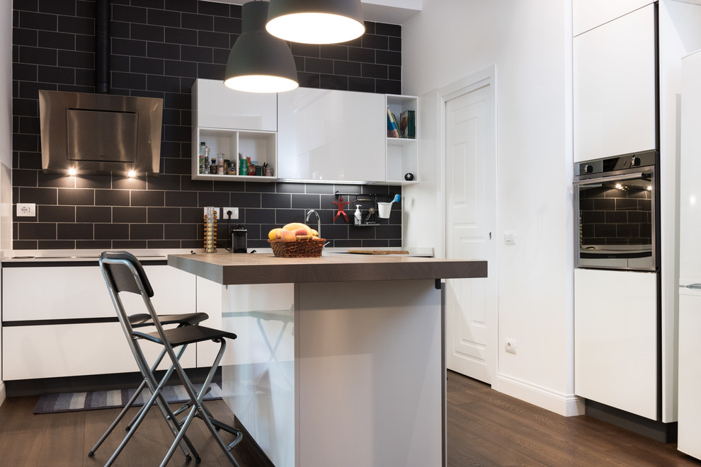 Photo of a large industrial single-wall eat-in kitchen in Rome with a drop-in sink, flat-panel cabinets, white cabinets, white appliances, dark hardwood floors and with island.