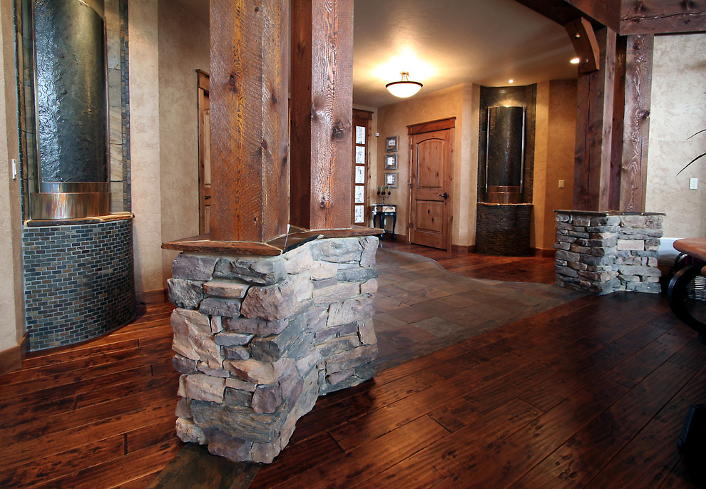 Large mountain style dark wood floor entry hall photo in Seattle with beige walls and a medium wood front door