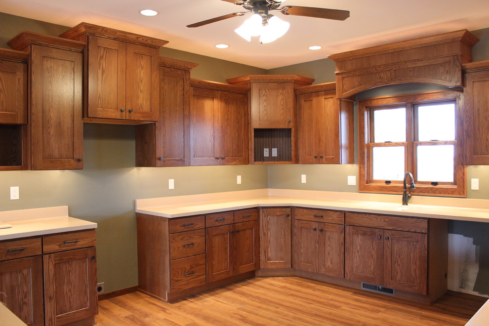 Example of a mid-sized transitional u-shaped dark wood floor and brown floor eat-in kitchen design in Cedar Rapids with a double-bowl sink, shaker cabinets, dark wood cabinets, granite countertops, beige backsplash, stone tile backsplash, stainless steel appliances and an island