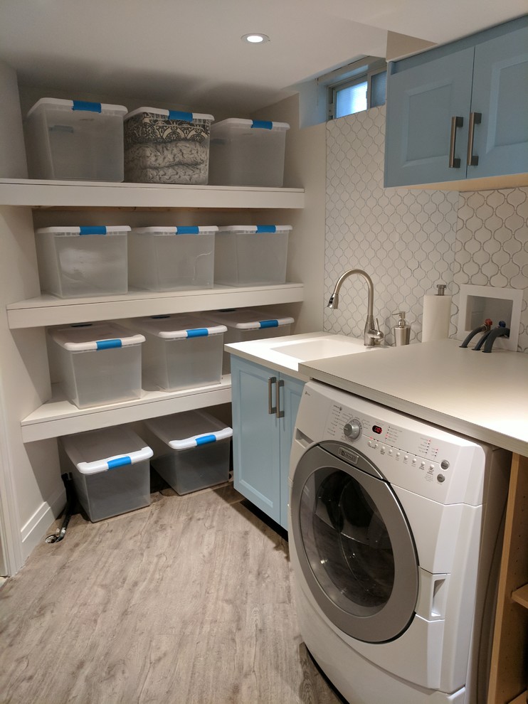 Design ideas for a transitional laundry room in Toronto.