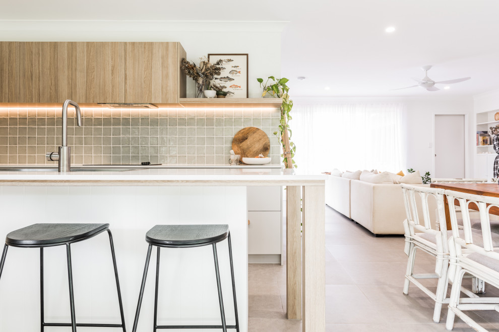 Inspiration for a contemporary galley open plan kitchen in Gold Coast - Tweed with green splashback, ceramic splashback, stainless steel appliances, with island, an undermount sink, flat-panel cabinets, white cabinets and grey floor.