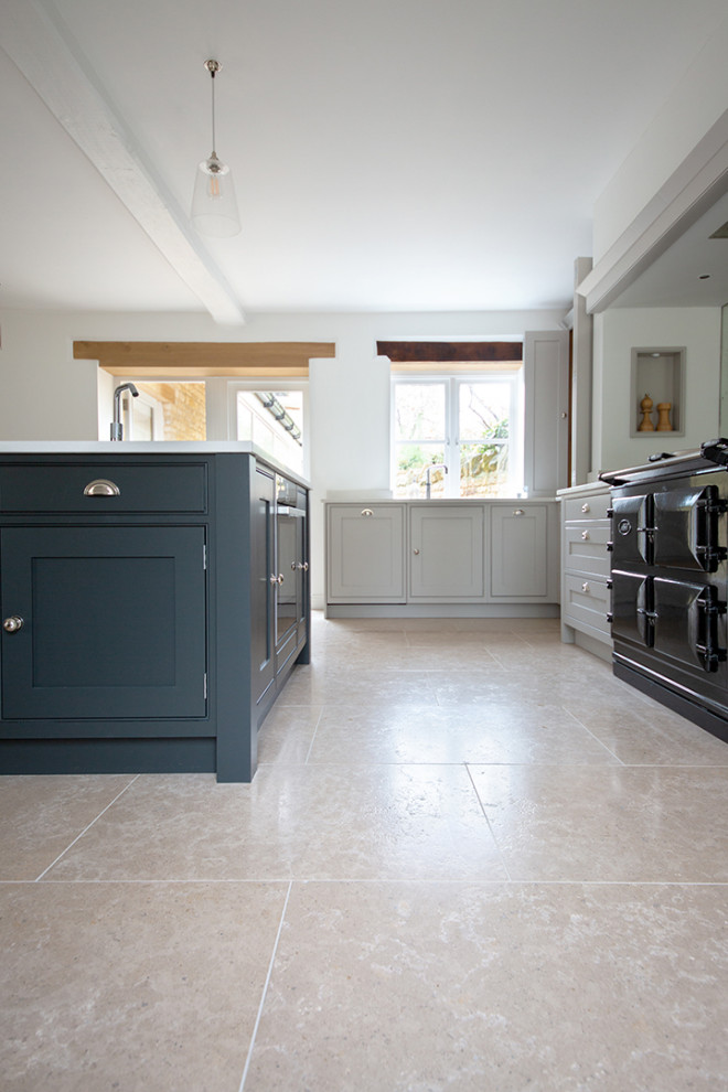 Inspiration for a large country kitchen in Other with limestone floors and beige floor.